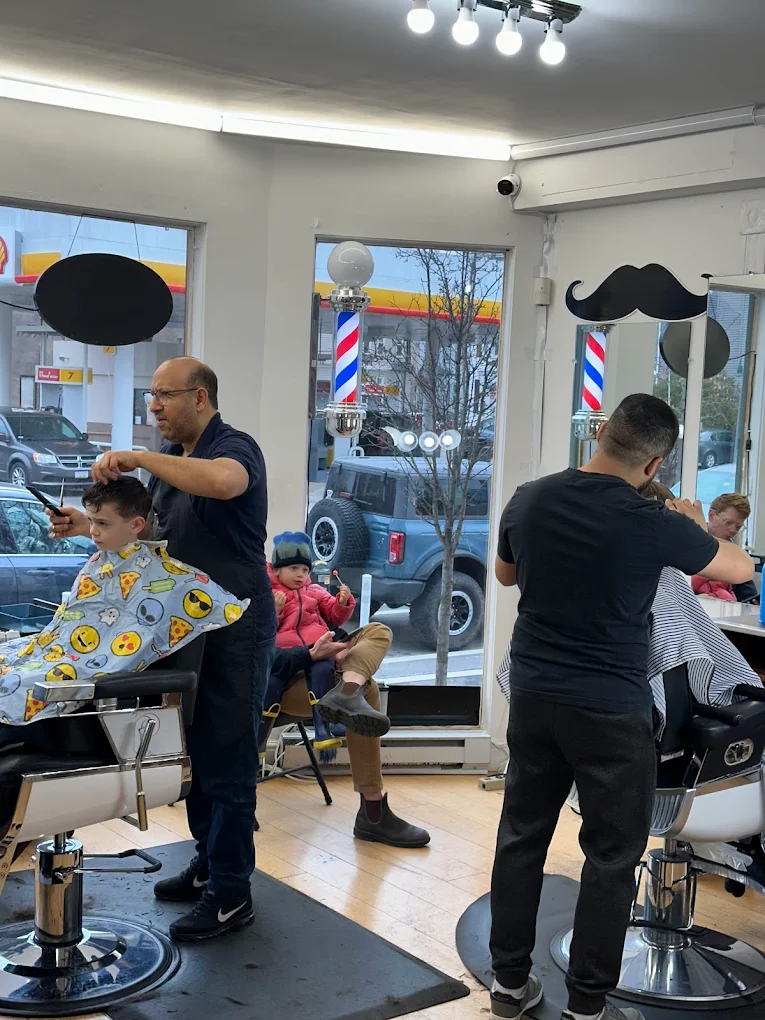 Barbers cutting hair inside CHAIR 186 in Cambridge